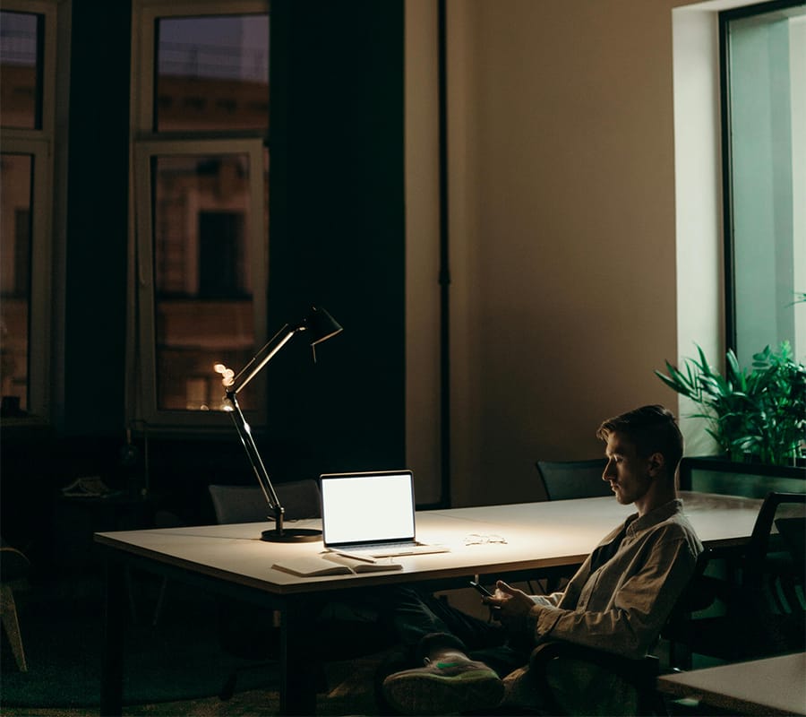 End of day insights man reflecting on the days work at his desk
