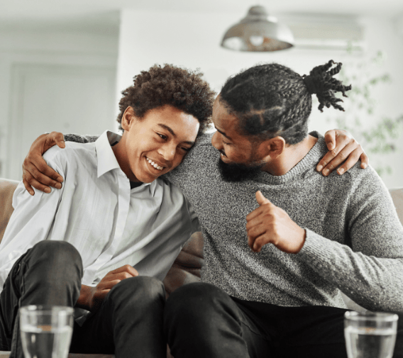 children's home staff member embracing a happy young person